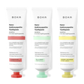 Three tubes of Boka Nano-Hydroxyapatite Toothpaste with different colored caps on a white background.