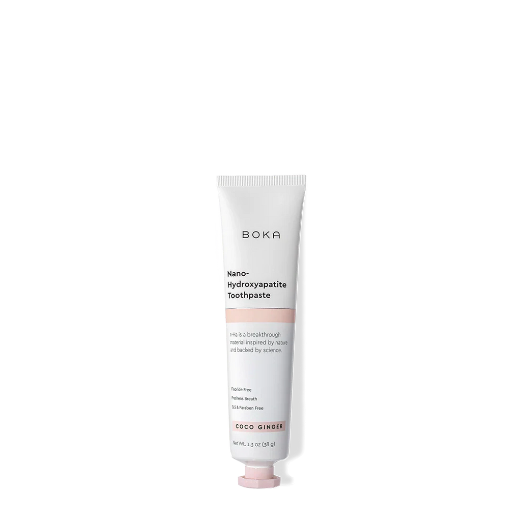 A tube of Coco Ginger Travel Size n-Ha Toothpaste on a plain background.