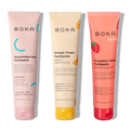 Three tubes of Boka toothpaste in different flavors on a white background